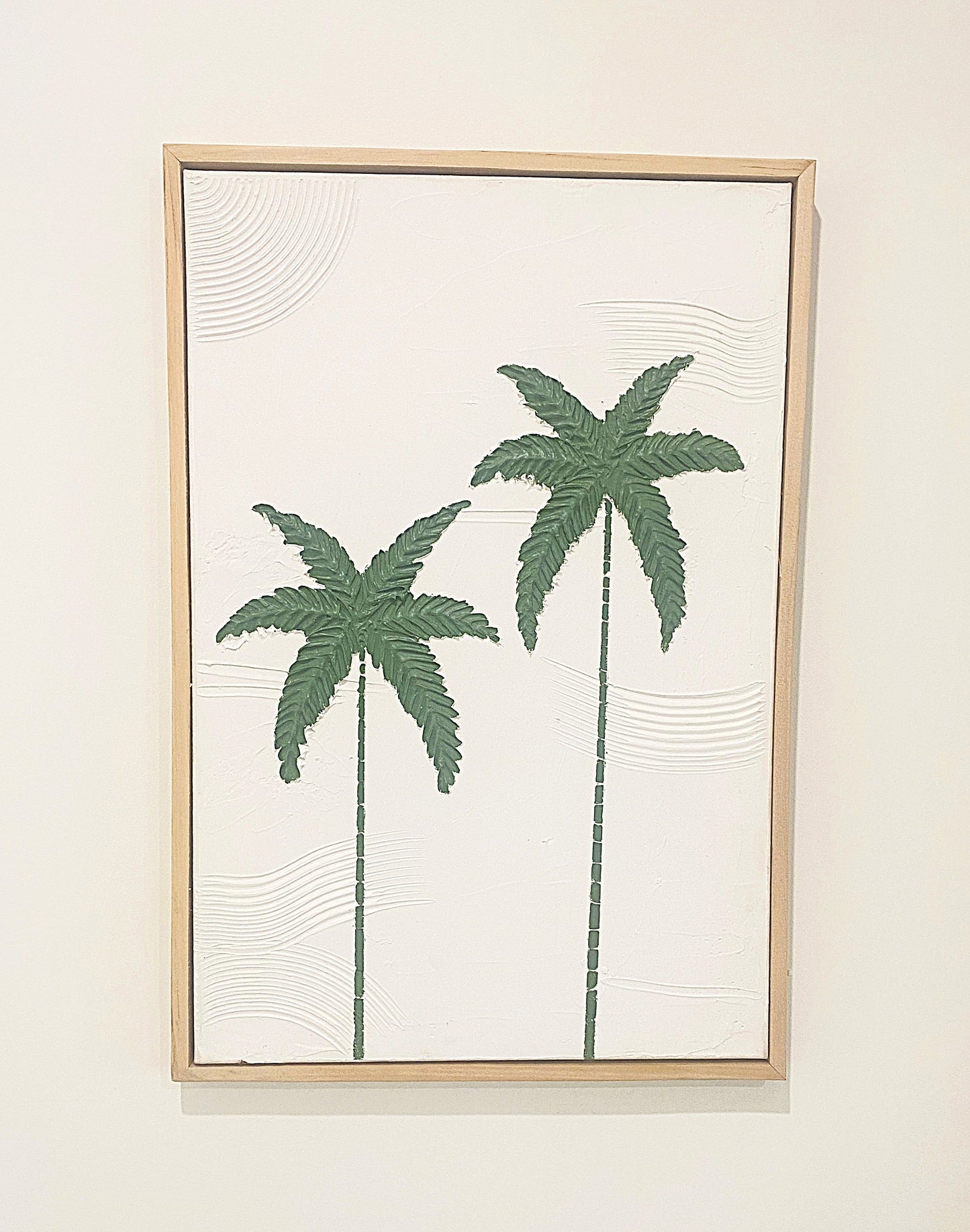 Framed textured artwork with green palm tree design on a white background