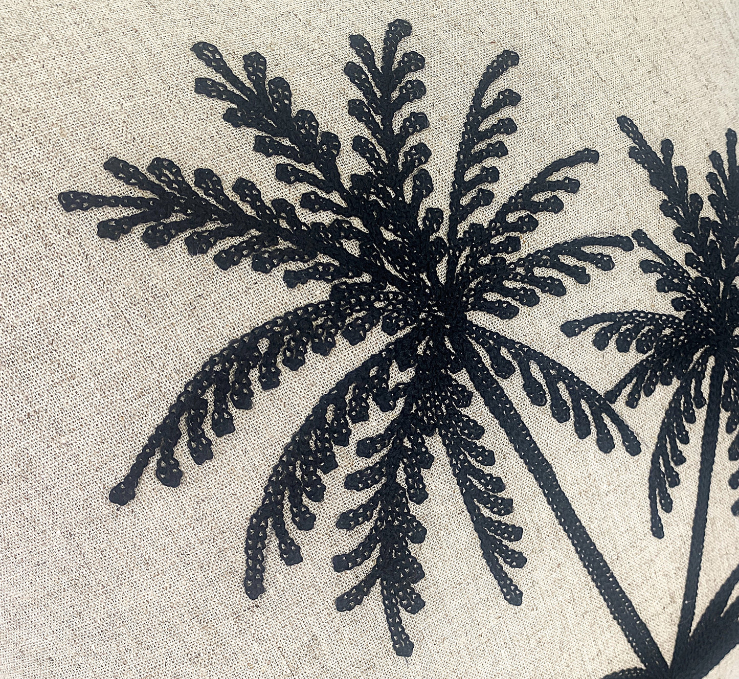 Natural cushion with black twin palm trees embroidered detail view