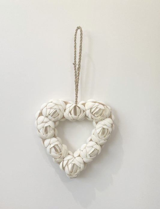 Heart-shape shell flower design decorative wall art pendant made of knotted fabric on a white background