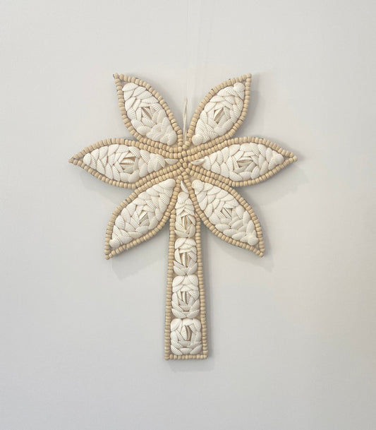 Decorative palm tree wall art with floral shell pattern and wooden beads on a light gray background