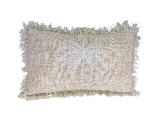 Textured pillow with palm tree design on a white background