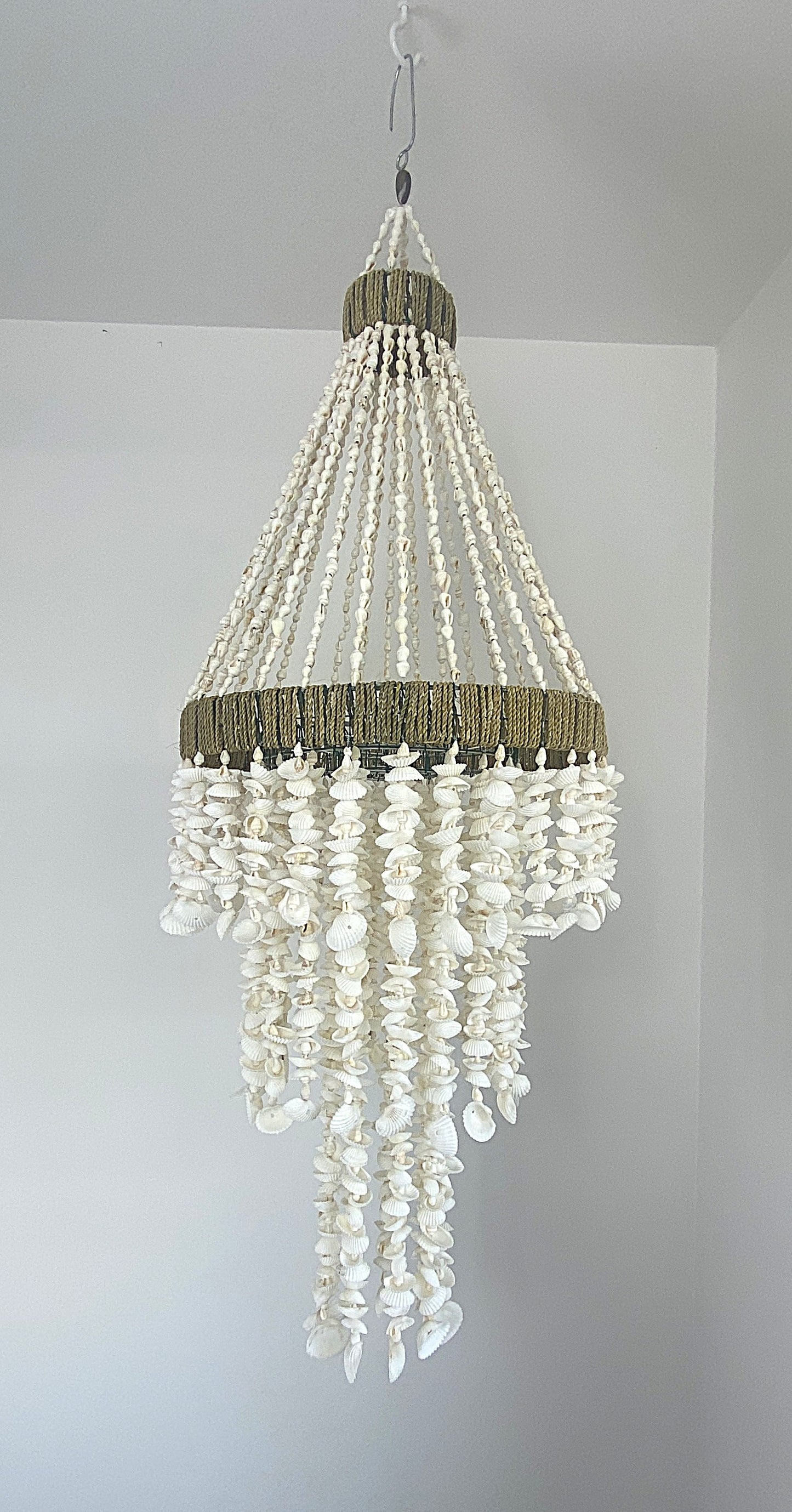 Diamond shaped Shell Chandelier with hand strung strands of textured and smooth shells 
