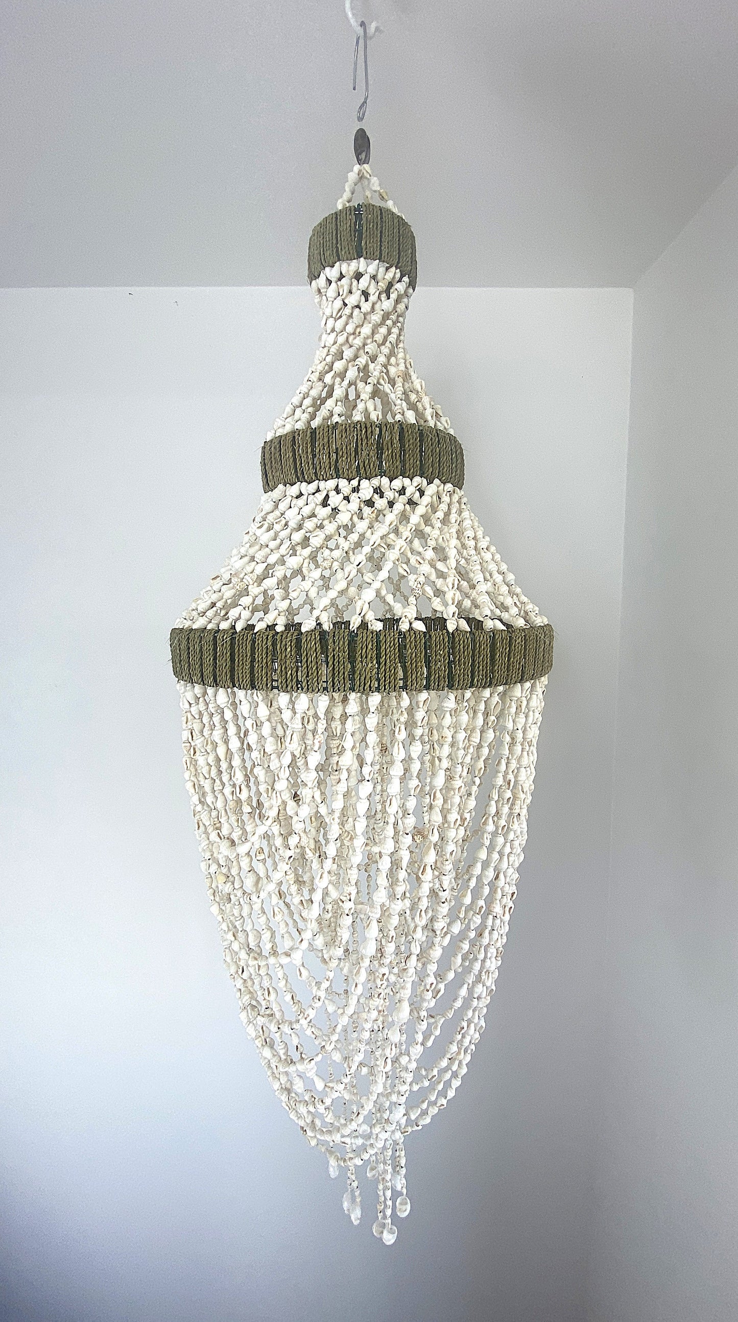 Handwoven strands of shells in the shape of a teardrop. Shell Chandelier 80cm long