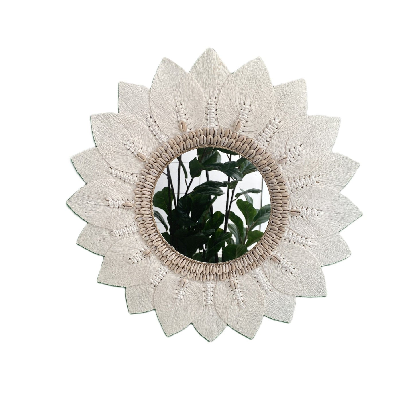 Decorative macrame and shell wall mirror with floral design on a white background