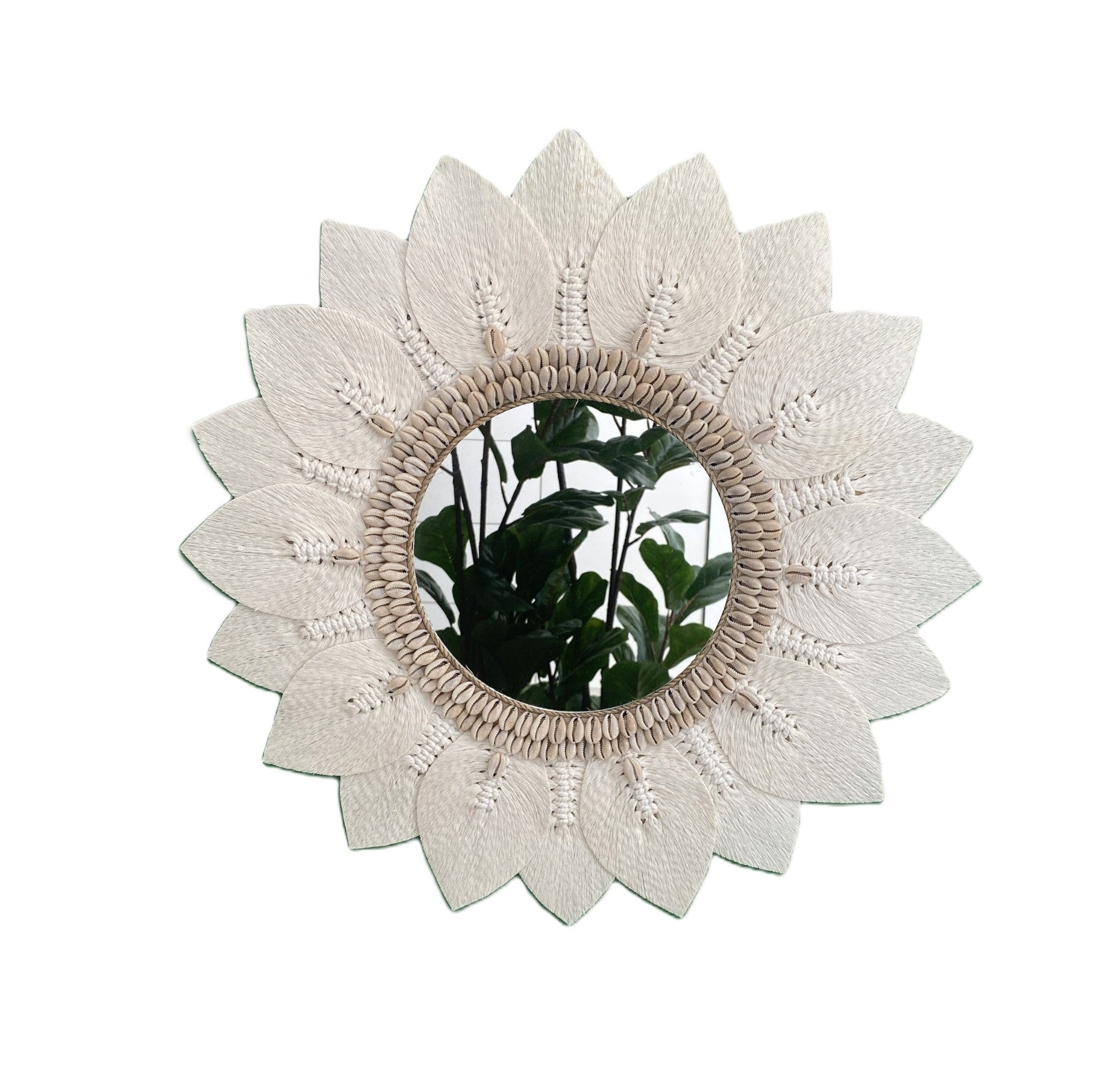Decorative macrame and shell wall mirror with floral design on a white background