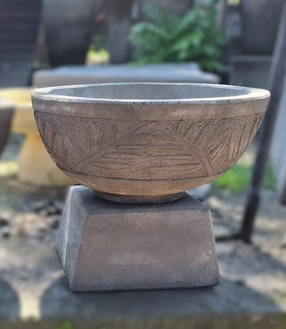 Decorative concrete bird bath bowl on a pedestal 