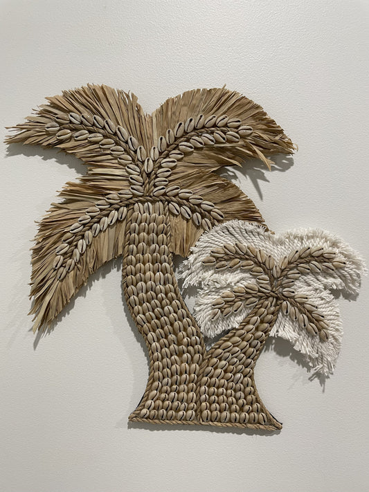 Shell and raffia and cotton twin palm tree design wall art on a plain background