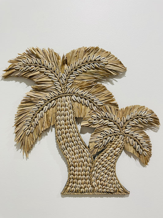Textured shell and raffia palm tree design wall art on a plain background
